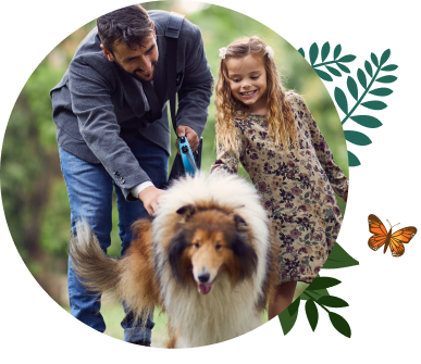 A father and his daughter taking their dog on a walk.