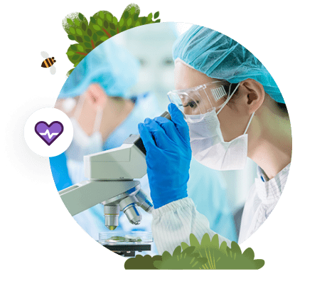 Medical technician looking into microscope.